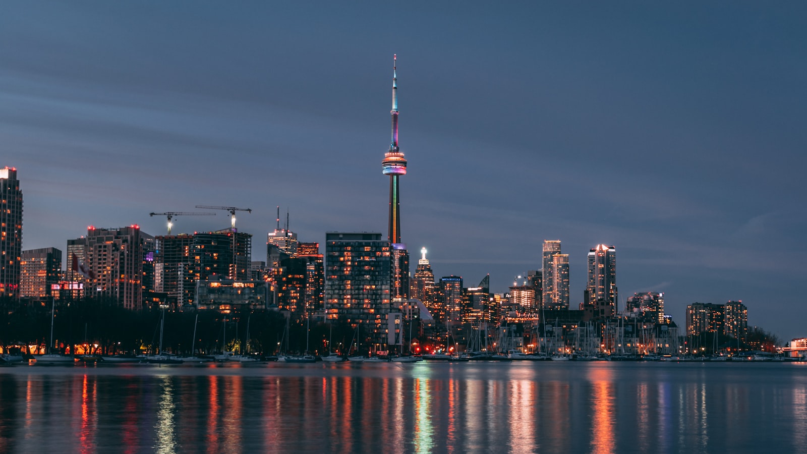 The Toronto skyline and CN Tower reflected at night