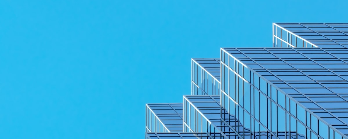 A stepped glass tower ascending against a clear sky