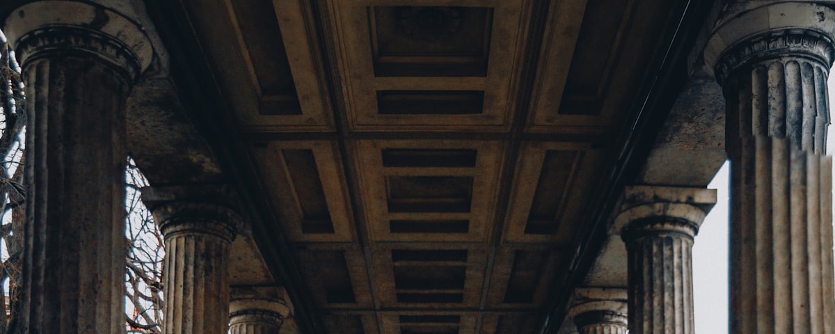 A long colonnade of stone columns receding into the distance