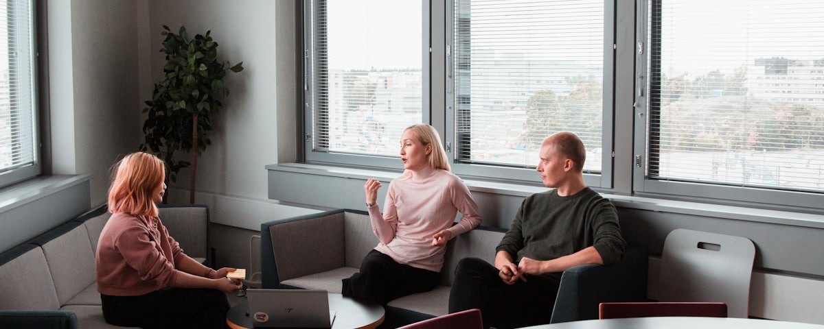 A relaxed conversation between people seated in a bright room